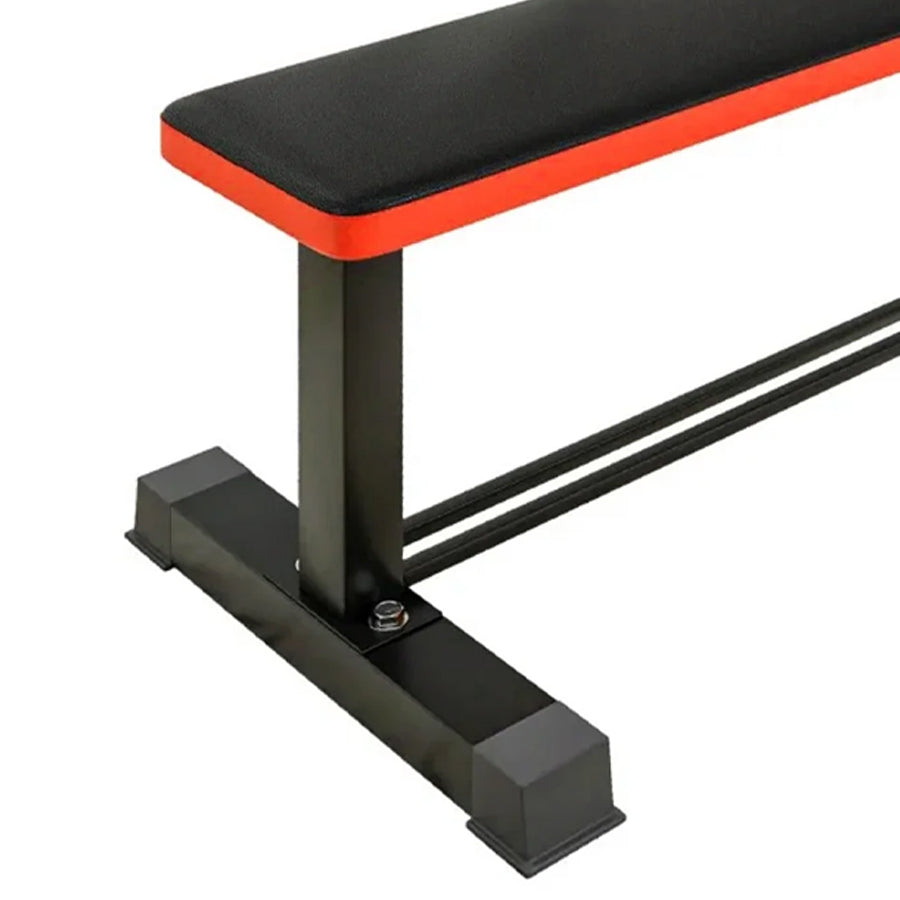 Black weight bench with red padding on a white background