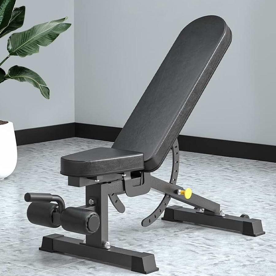 Black adjustable weight bench in a room with a plant and tiled floor.