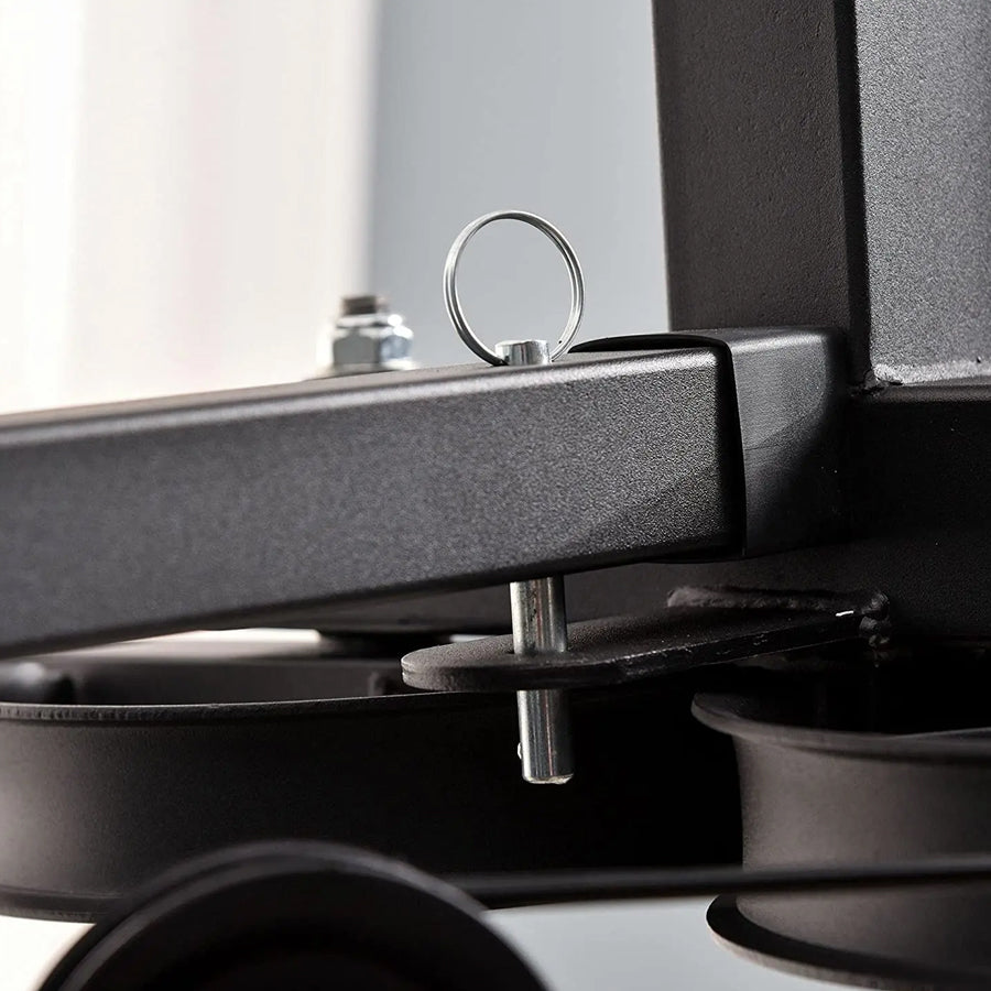 Close-up of a black metal object with a circular component on a white background