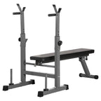 Adjustable weight bench with barbell rack and dip station, made of steel, in gray color, with a flat position backrest and an integrated dip bar.