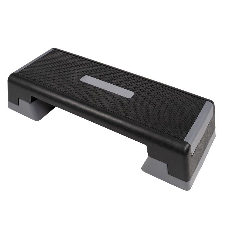 A black aerobic stepper platform with a non-slip surface and adjustable height levels.