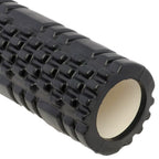 Black textured foam roller with beige center on white background