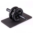 Black ab roller on a black mat against a white background