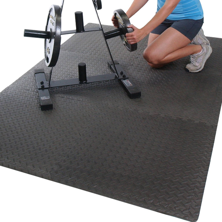 Person lifting a barbell on a weightlifting platform.