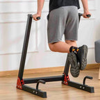 Person using a black exercise device on a wooden floor.