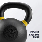 Close-up of a black cast iron kettlebell with yellow bands near the handle, embossed weight marking '16KG 35LB', and text on the right reading 'PREMIUM CAST IRON FINISH' on a light gray background.