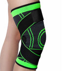 Black and green knee brace on a person's knee against a white background