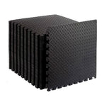 Interlocking black EVA foam tiles with a puzzle-like design, showing shock absorption and non-slip surface texture.
