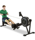 Man using a rowing machine on a white background