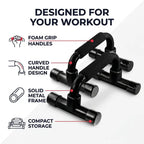 Black foam push-up bar set with text callouts reading 'DESIGNED FOR YOUR WORKOUT' and features labeled 'FOAM GRIP HANDLES,' 'CURVED HANDLE DESIGN,' 'SOLID METAL FRAME,' and 'COMPACT STORAGE' on a light gray background.