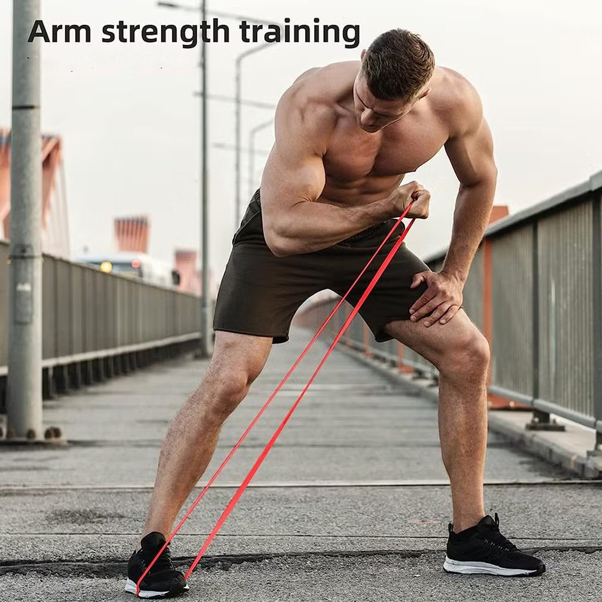 Man performing arm strength training with resistance bands on a bridge.