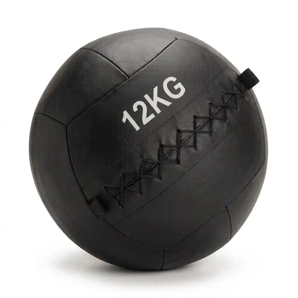 A black 12kg leather medicine ball with white printed text and black diamond-stitched seams, shown on a white background.