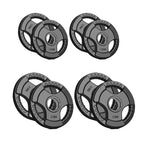 Set of four weight plates with different weights on a white background