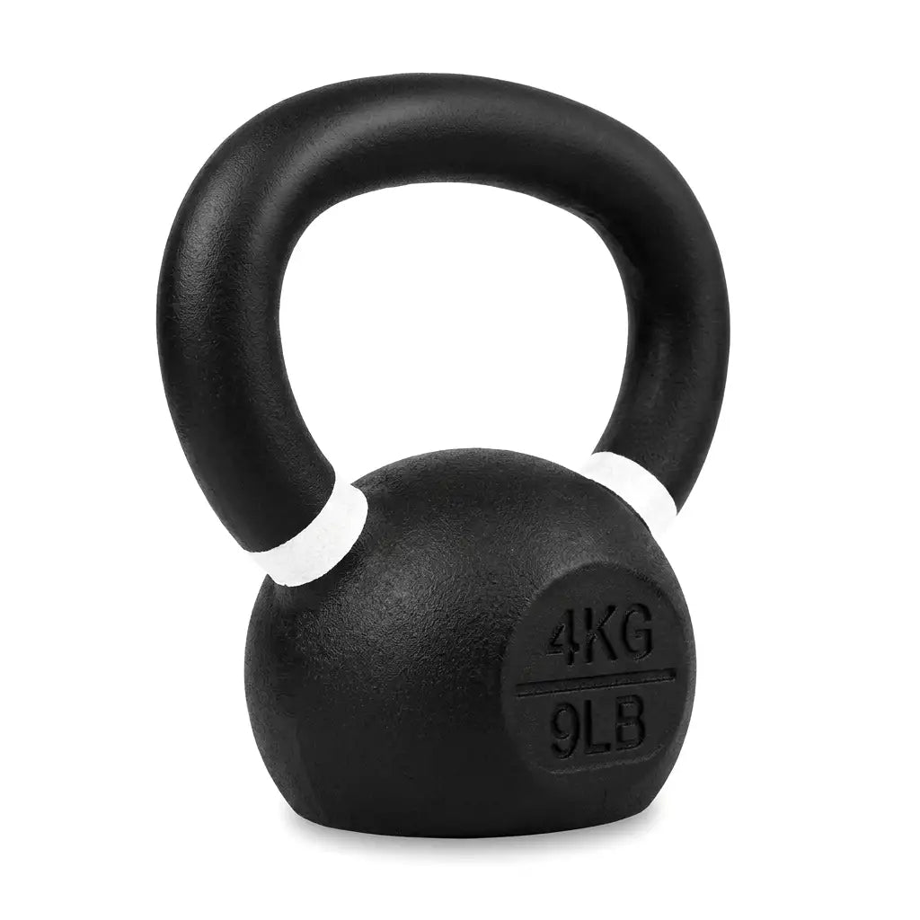 A black cast iron kettlebell with a textured finish, featuring white painted accents on the rim and a circular weight marking embossed with '4KG 9LB' on the front, set against a plain white background.