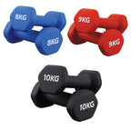 Set of red, black and blue dumbbells with weight markings on a white background