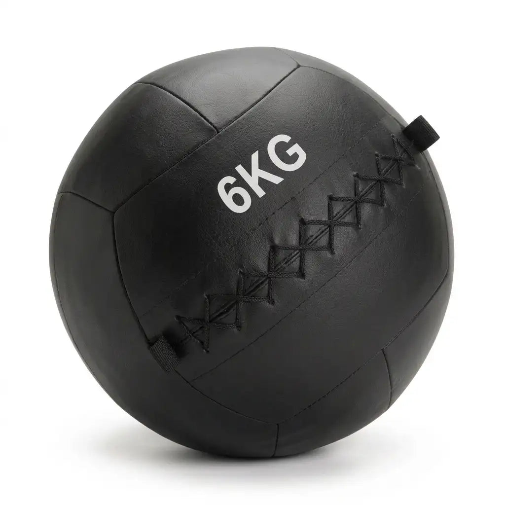A black 6kg medicine ball with white printed text and black diamond-stitched seams, shown on a clean white background.