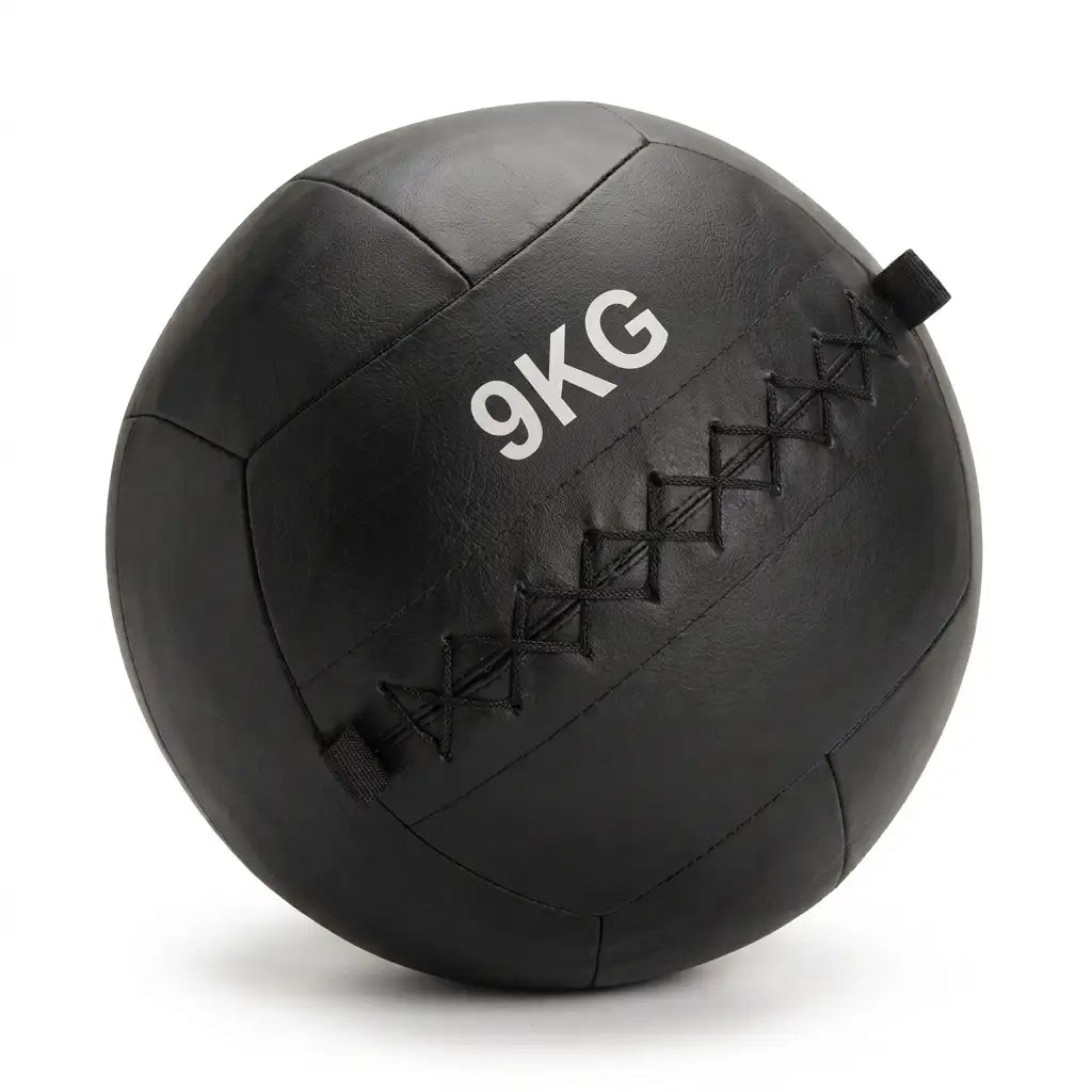 A black 9kg leather medicine ball with black diamond-stitched seams and white printed '9KG' text, shown on a white background.