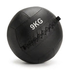 A black 9kg leather medicine ball with black diamond-stitched seams and white printed '9KG' text, shown on a white background.