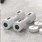 Set of white dumbbells with black circular ends on a gray surface