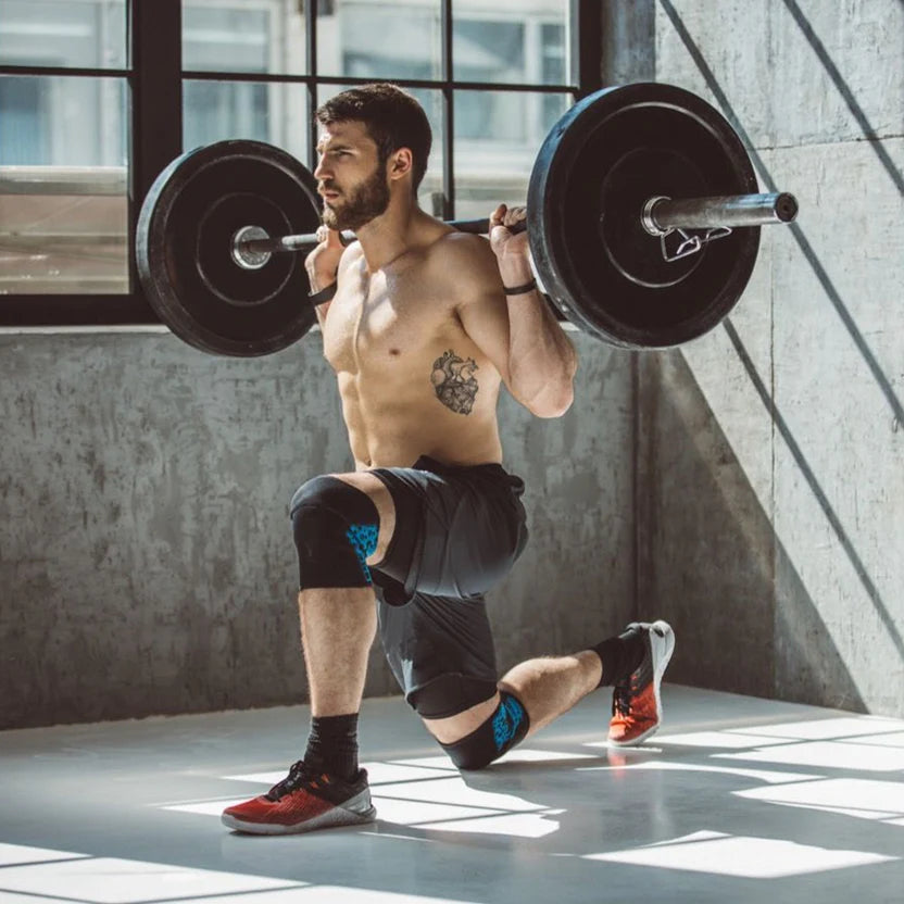 Man lifting a barbell in a gym setting