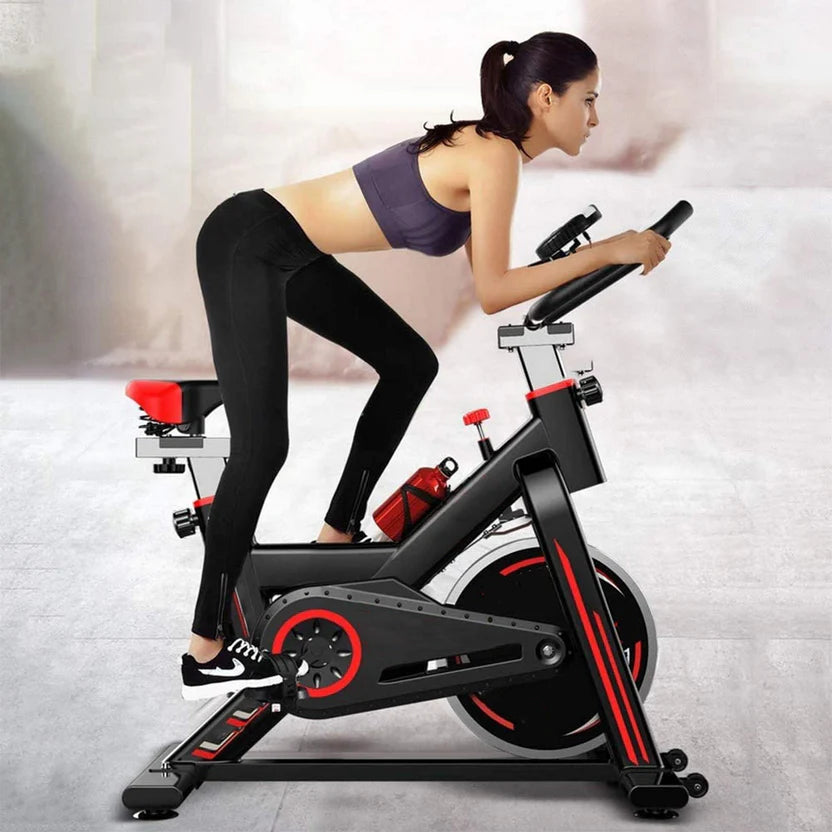 Woman exercising on a stationary bike in a gym setting