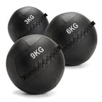 Three black rubber medicine balls in 3KG, 6KG, and 9KG sizes, arranged on a clean white background.