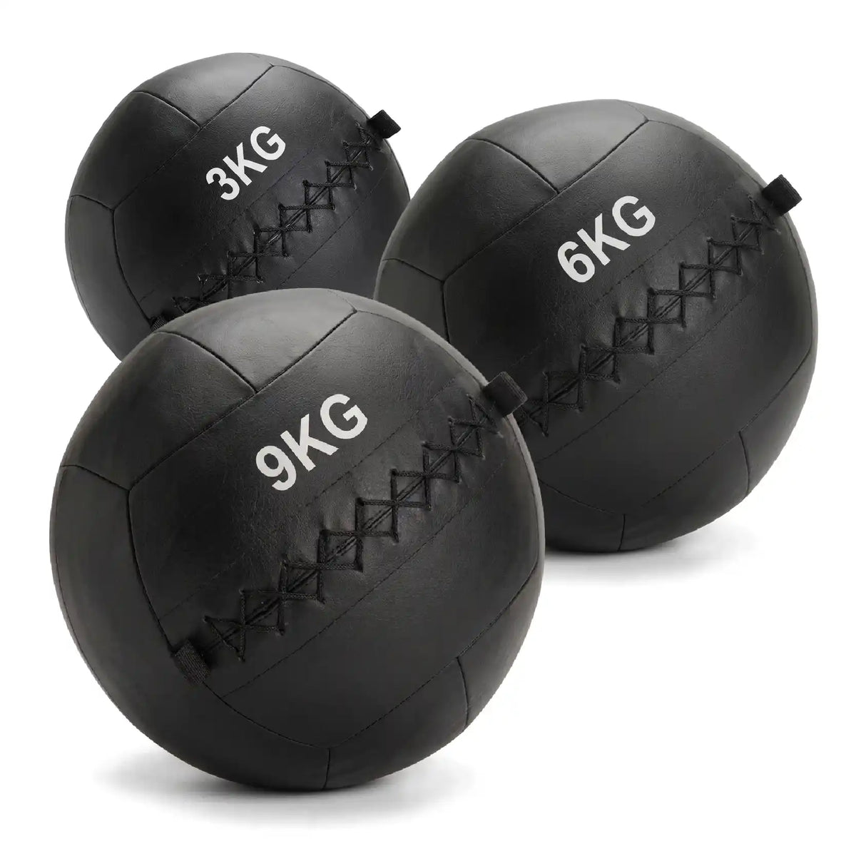 Three black rubber medicine balls in 3KG, 6KG, and 9KG sizes, arranged on a clean white background.