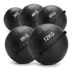 Five black rubber medicine balls in different weights (3KG, 4KG, 6KG, 9KG, 12KG) arranged on a white background.