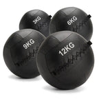 Four black rubber medicine balls in sizes 3KG, 6KG, 9KG, and 12KG, arranged on a white background.