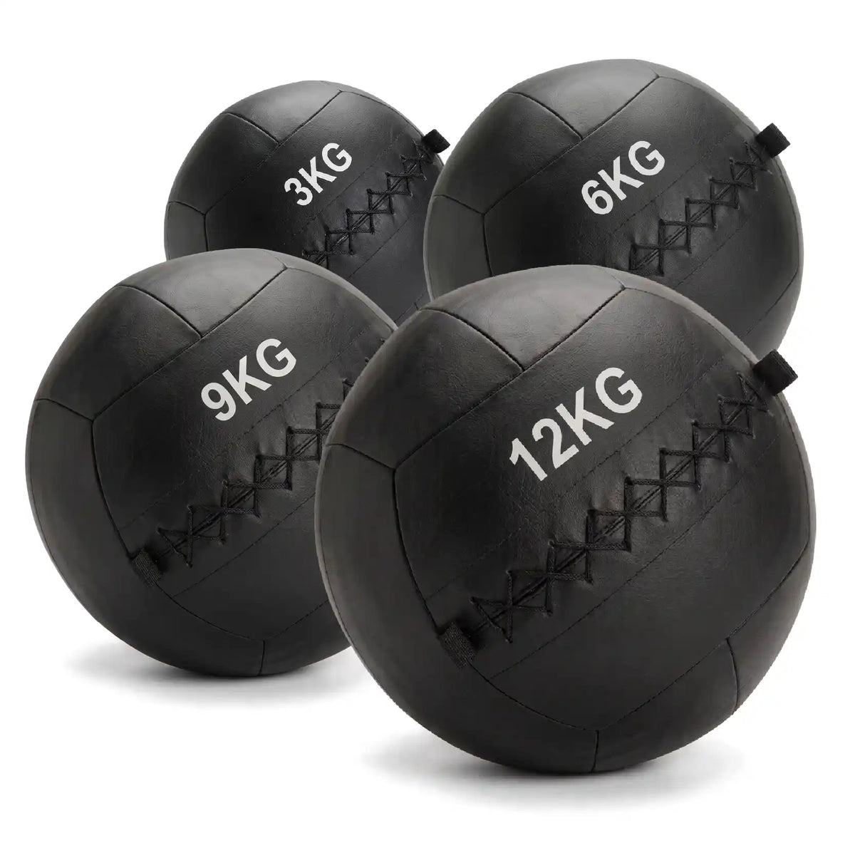 Four black rubber medicine balls in sizes 3KG, 6KG, 9KG, and 12KG, arranged on a white background.