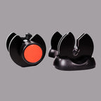 Black and red camera lens cap with a gray background