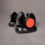 Black and red dumbbell-shaped object on a gray background
