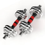 Pair of chrome dumbbells with red and black resistance bands on a white background