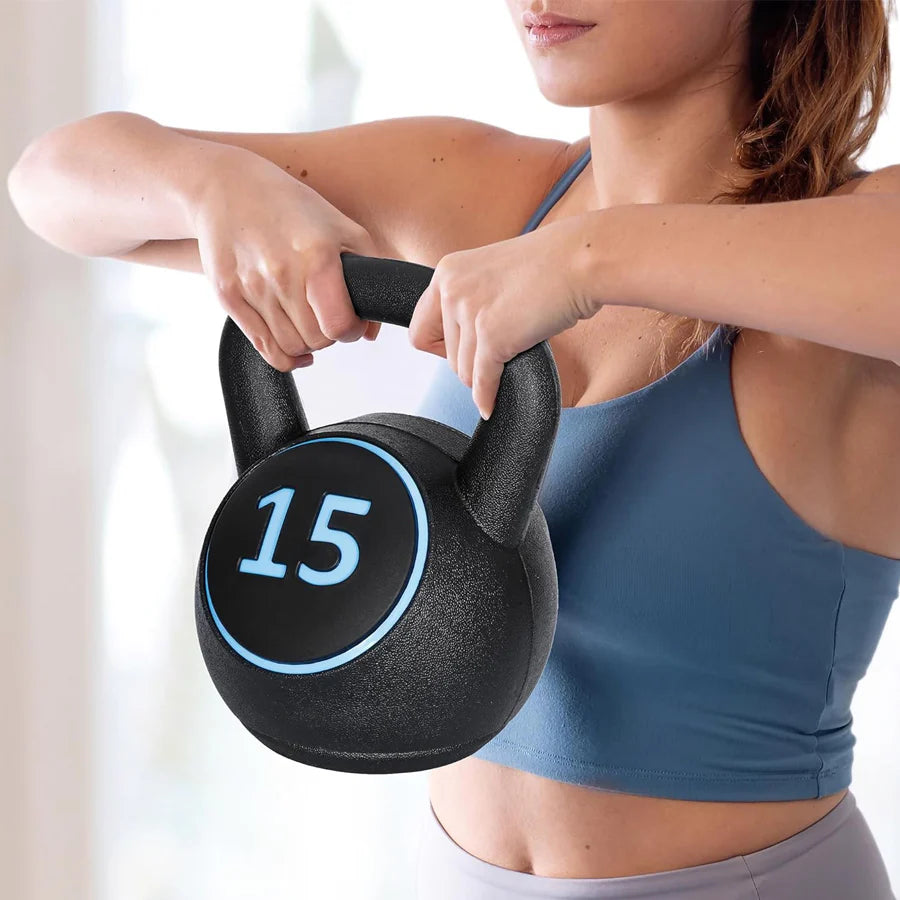 Woman holding a black kettlebell with the number 15 on a blurred background