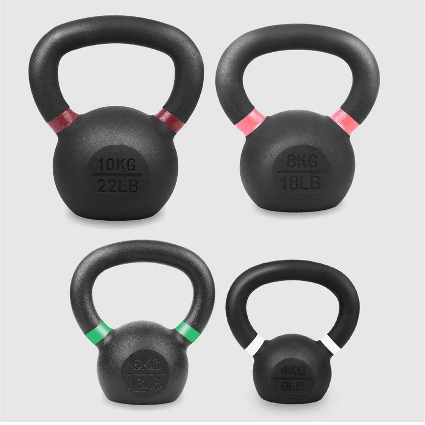 Set of black kettlebells with weight markings on a light gray background