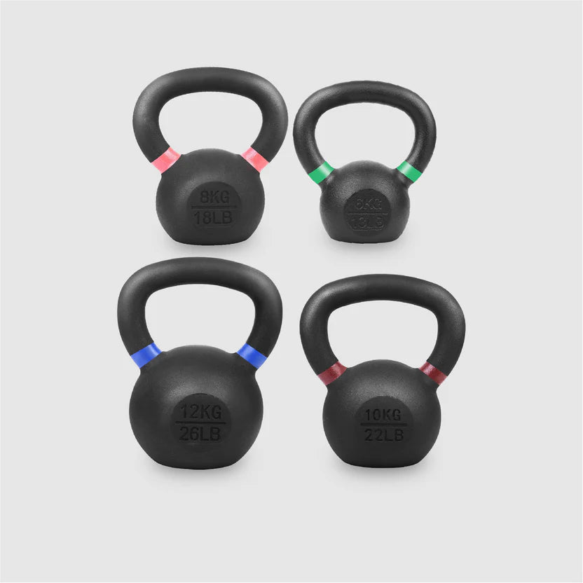 Four black kettlebells with weight markings on a light gray background
