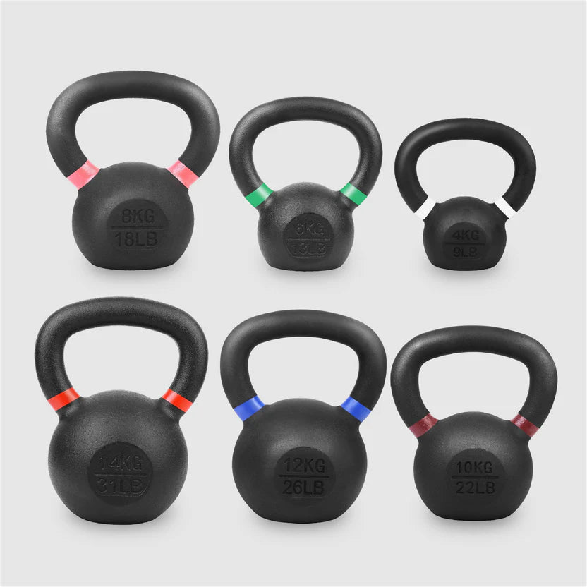 Set of six black kettlebells with color-coded weight markings on a light gray background