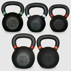 Set of five black kettlebells with labeled weights on a white background