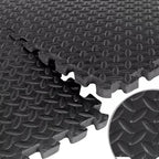 Stack of black interlocking foam mats with textured surface