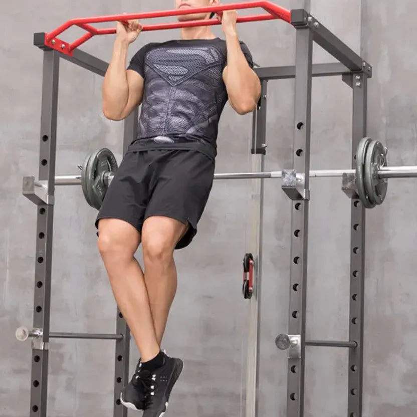 Person performing pull-ups on a bar in a gym setting