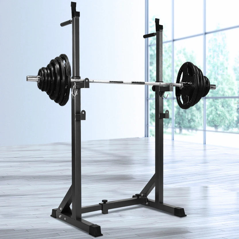Weight lifting rack with barbell and weights on a light wooden floor.