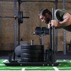 Man lifting weights on a squat rack in a gym setting