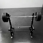 Barbell with weights on a weightlifting platform against a plain background