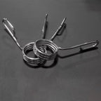 Metal spring with carabiner on a gray background