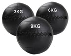 A black, double-stitched, textured wall ball with the weight '3KG,6KG,9KG' printed on it.