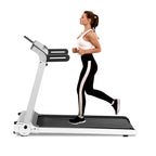 Woman running on a treadmill with a white background