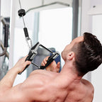 Man exercising on a cable machine in a gym setting