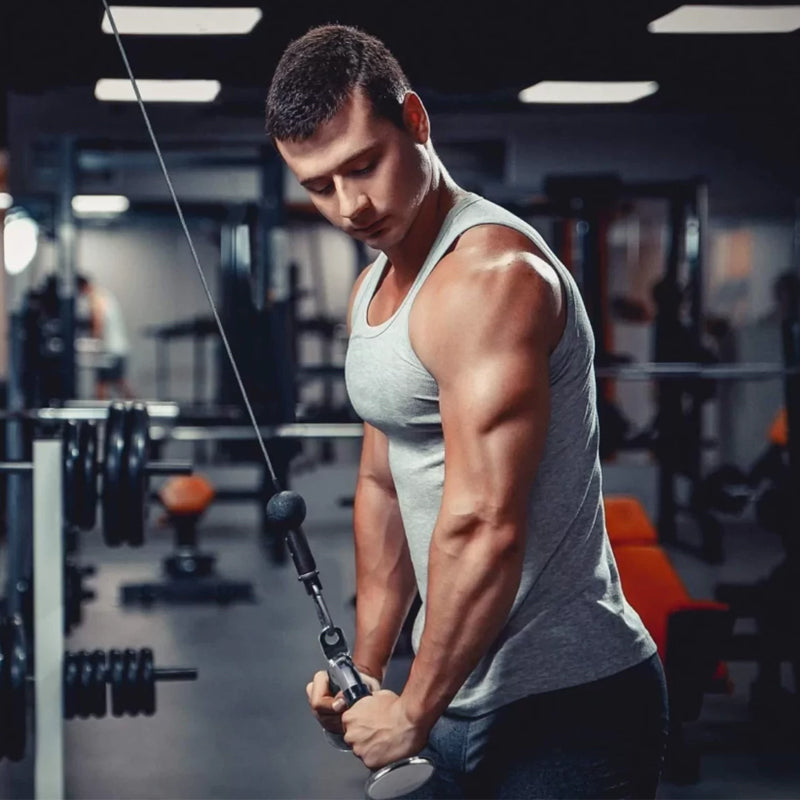 Man exercising with cable machine in a gym setting