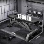 Gym weight bench with weight plates and measurements on a black mat.