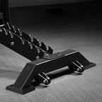 Black metal car jack stand on a textured gray surface